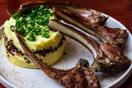 Baked smoked pork ribs with sauces served on wooden tableの写真素材