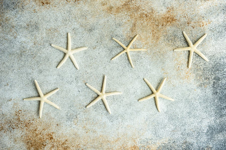 Flat lay summer composition with sea stars on concrete background with copy spaceの写真素材
