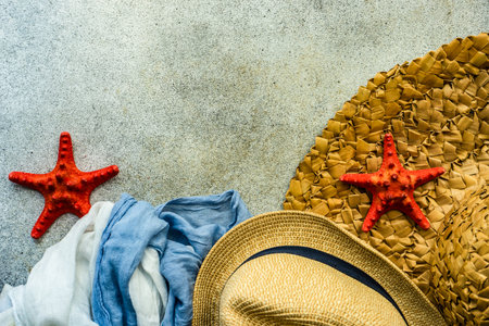Summer background flat lay with straw hat and sea starsの写真素材