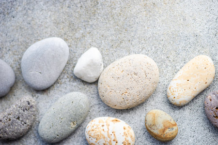 Summer time card concept with sea stones on concrete background
