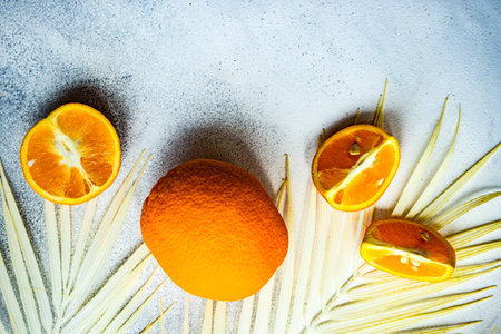 Summer background with slices of organic fresh ripe orange fruits on concrete backgroundの写真素材