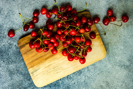 Summer background with ripe sweet cherries on wooden boardの写真素材