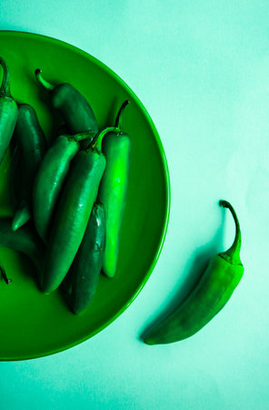 Cooking concept with gresh raw peppers on stone background