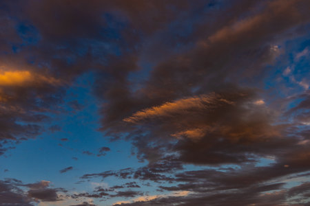 Summer background with moody blue and red sunrising skyの写真素材