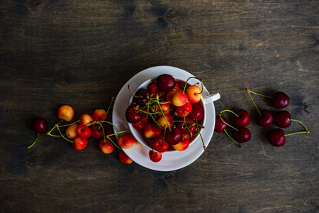 Summer background with ripe sweet cherries in wooden  bowlsの写真素材