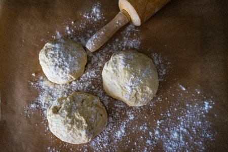 Pizza cooking concept with dough heads on the baking paper