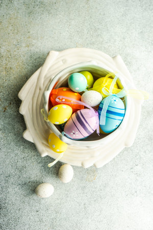 Festive table setting for holiday Easter dinner with bowl full of colore eggs