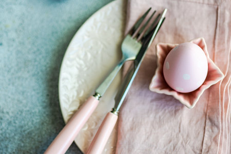 Festive table setting for holiday Easter dinner in pink colorの写真素材