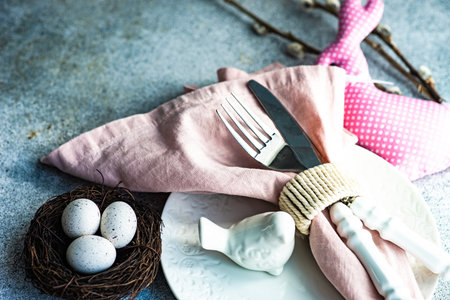 Festive table setting for holiday Easter dinner in pale pink colorの写真素材