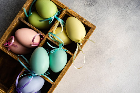 Box full of colorful eggs on rustic backgroundの写真素材