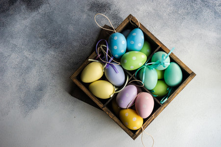 Box full of colorful eggs on rustic backgroundの写真素材