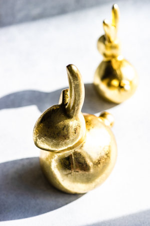 Easter card concept with golden bunnies on concrete background with copy spaceの写真素材
