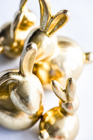 Easter card concept with golden bunnies on concrete background with copy spaceの写真素材