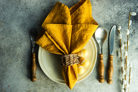 Easter dinner place setting on concrete backgroundの写真素材