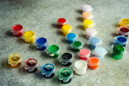Crafting tools with different colors painting on concrete background