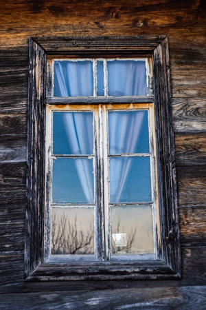 Old wooden wall with vintage style window in houseの写真素材