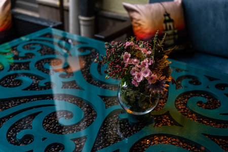 Festive autumnal table decoration with pumpkin and flowersの写真素材