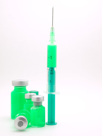 Medical syringe and phials. On white background.の写真素材