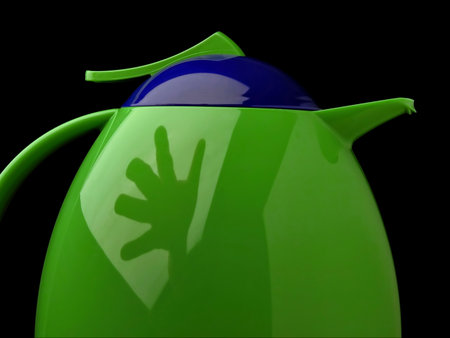 Thermos with reflection of stretching hand. Symbols - hot drink, coffee, rest, tea, cooking, comfort, life, morning, ceremony. Colors - blue, green.の写真素材