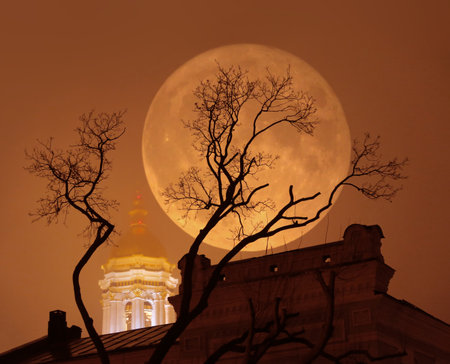 Supermoon, a rare astronomical full moon phenomenon. Moon is bigger as normal in the sky. Mist, photo illustration with double exposure.の写真素材