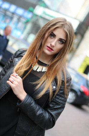 Leather jacket, long hair, makeup, street fashion, diagonal composition.の写真素材