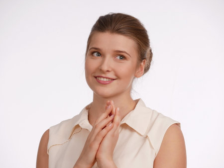 Isolated, portrait, smile, happiness,  Hands near face, folded, as in applause.の写真素材