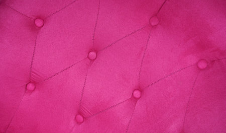 Close-up pink luxury buttoned velvet. The back of sofa fuchsia colorの写真素材