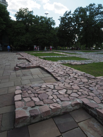 The foundation of theThe Church of the Tithes or Church of the Dormition of the Virgin, Kiev, Ukraine in the backlight. Running Man. Sun, rays, sky, clouds. Tourist attraction. Andriyivskyy Descent.の写真素材