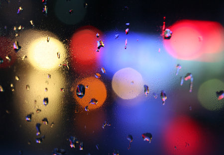 Color defocused background with raindrops on the window. Colors: yellow, red, violet, green, orange. Seamless multicolor blurred pattern.の写真素材