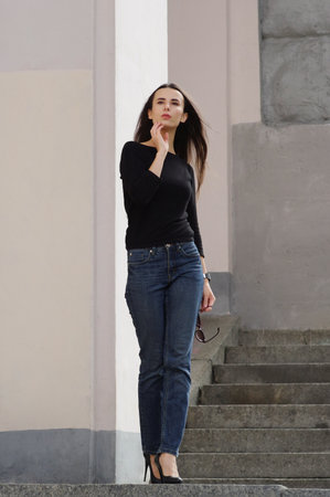 Pretty female posing in a casual street style apparel. With sunglasses in hand.の写真素材