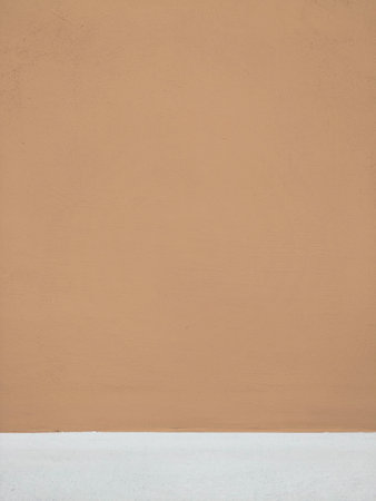 Orange color outdoor wall surface, painted with bottom white stripe. Wall with small brush strokes wery little contrast perfect as background for illustration space for textの写真素材