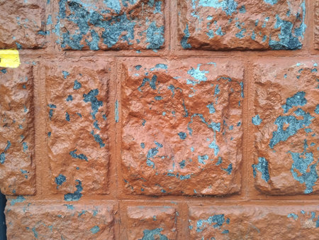 Textured facing of the exterior of the building from large square and rectangular blocks, coarsely hewn folded in the style of brickwork, with a peeling surface, worn out by time, retroの写真素材