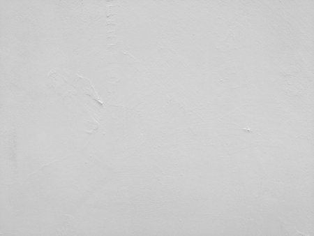 White-gray plastered surface, painted. Wall with weathered areas of peeling paint with small cracks little contrast perfectly as background for illustration space for textの写真素材
