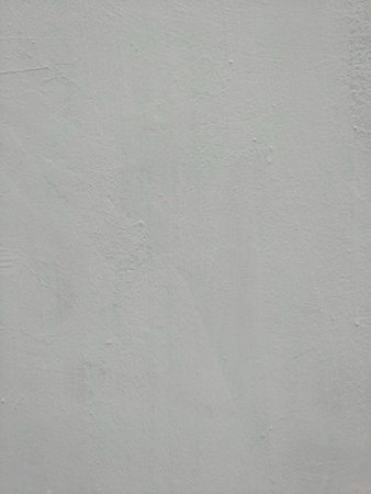 White-gray plastered surface, painted. Wall with weathered areas of peeling paint with small cracks little contrast perfectly as background for illustration space for textの写真素材