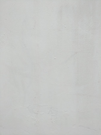 White-gray plastered surface, painted. Wall with weathered areas of peeling paint with small cracks...