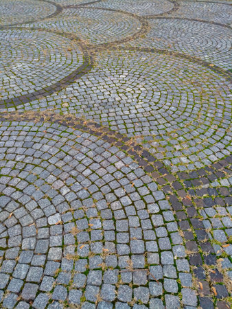 Paving slabs laid out on the street in the form of fish scales, road covering, architecture, decorationの写真素材