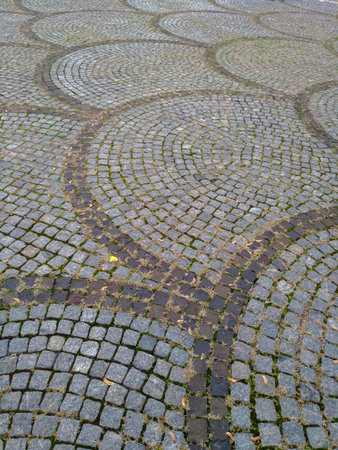 Paving slabs laid out on the street in the form of fish scales, road covering, architecture, decorationの写真素材