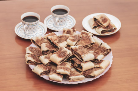 cookies on a plate and two cups of coffeeの写真素材