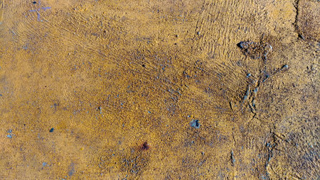 Textured rusty metal surface with brown yellow shades with a pronounced texture of the corroded iron...