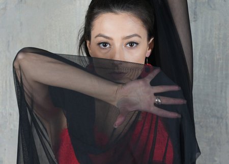 Woman dancer with cloth, face portrait in motion indoorsの写真素材