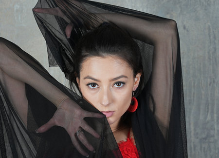 Woman dancer with cloth, face portrait in motion indoorsの写真素材