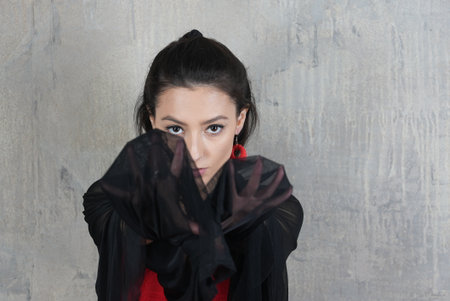 Woman dancer with cloth, face portrait in motion indoorsの写真素材