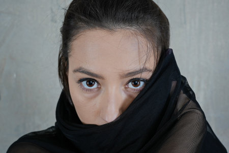 Woman dancer portrait in motion with a cloth partially covering face
