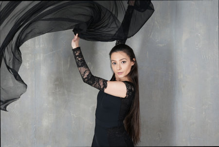 Woman dancer portrait in motion with a semitransparent clothの写真素材