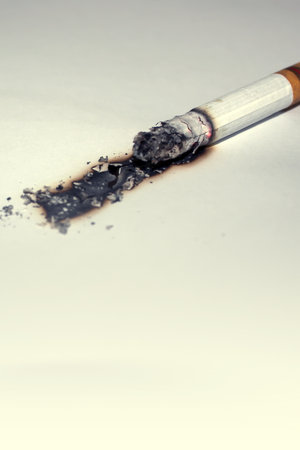 Cigarette burning white paper, closeup.の写真素材