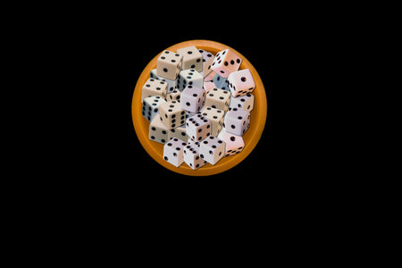 Glass with dice on a black background