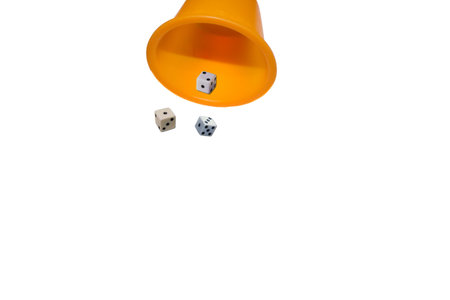 Glass with dice on a white backgroundの写真素材