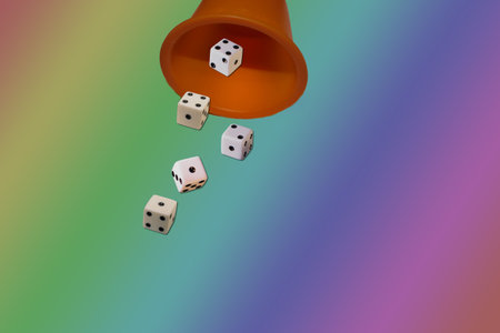 Glass with dice on the color backgroundの写真素材