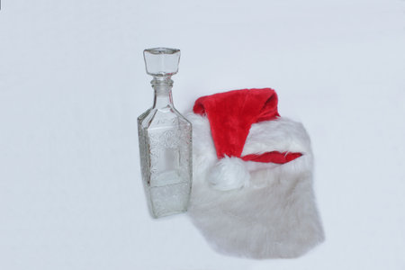 Vodka and a Santa Claus hat On a light backgroundの写真素材