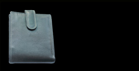 black leather wallet isolated on black backgroundの写真素材